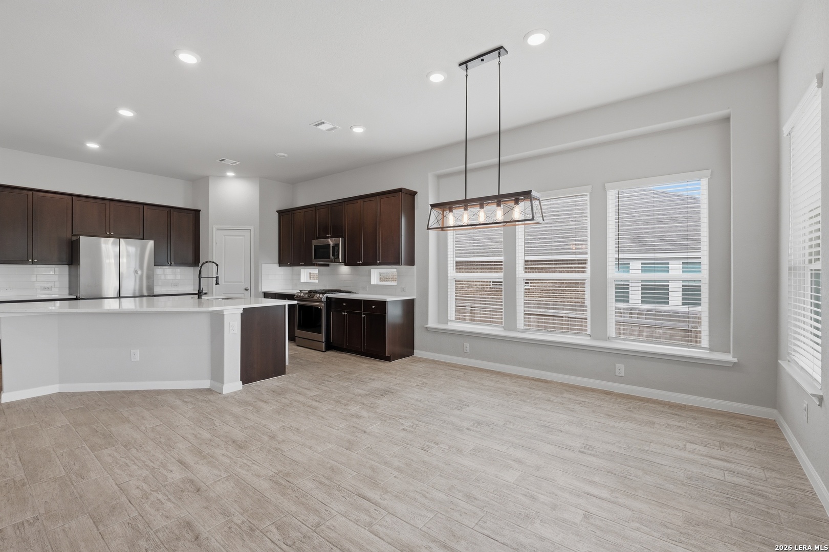 32125 Cardamom Way Bulverde, TX 78163 - Photo 14 of 32 a large kitchen with stainless steel appliances kitchen island a large counter top a sink stainless steel appliances and cabinets