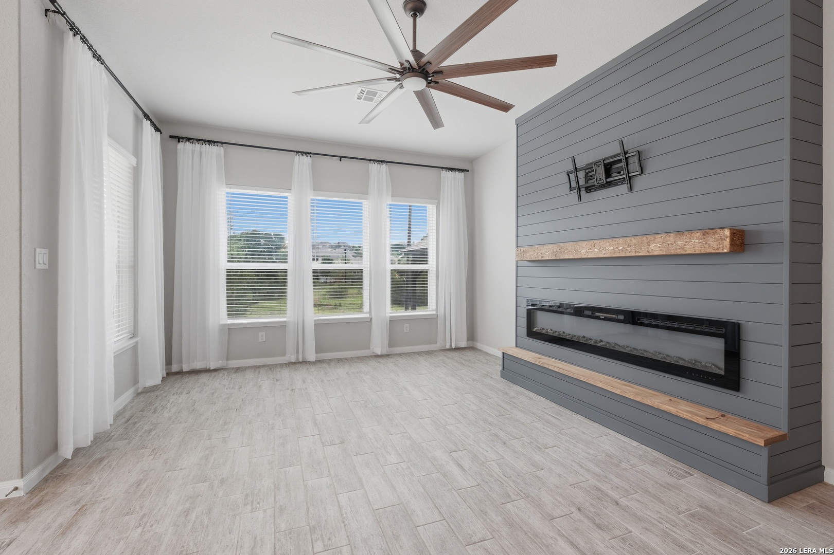 32125 Cardamom Way Bulverde, TX 78163 - Photo 5 of 32 a view of an empty room with a window and a kitchen