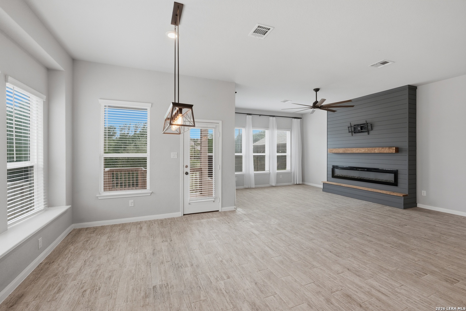 32125 Cardamom Way Bulverde, TX 78163 - Photo 6 of 32 a view of an empty room with a window and wooden floor