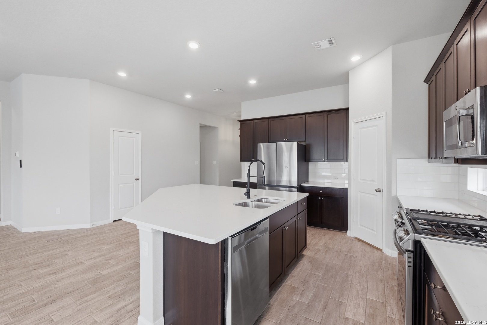 32125 Cardamom Way Bulverde, TX 78163 - Photo 10 of 32 a kitchen with a sink appliances and cabinets