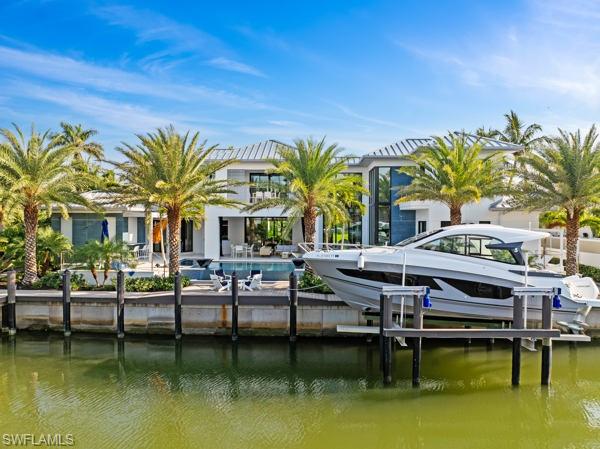 2201 Shad Court Naples, FL 34102 - Photo 20 of 25 a view of house with swimming pool and outdoor seating