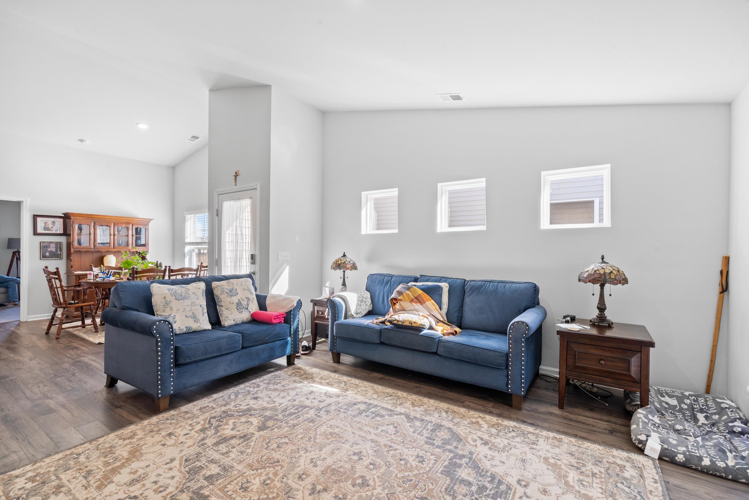 1404 Jardine Loop Little River, SC 29566 - Photo 12 of 31 Living room with vaulted ceiling and dark wood-style floors