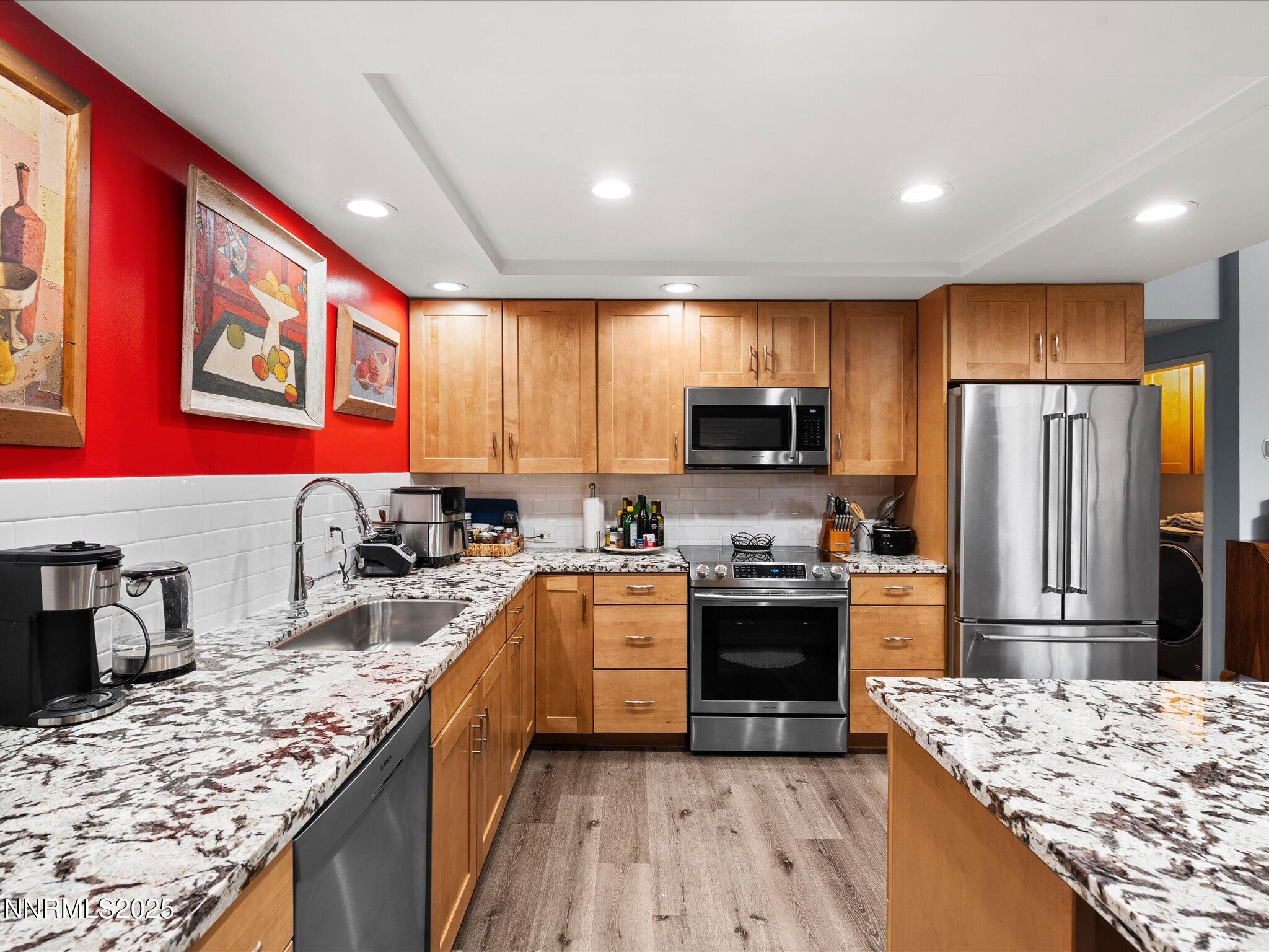 1200 Riverside Drive, Unit 1276 Reno, NV 89503 - Photo 1 of 47 a kitchen with stainless steel appliances granite countertop a stove top oven a sink dishwasher a refrigerator and a oven with wooden floor