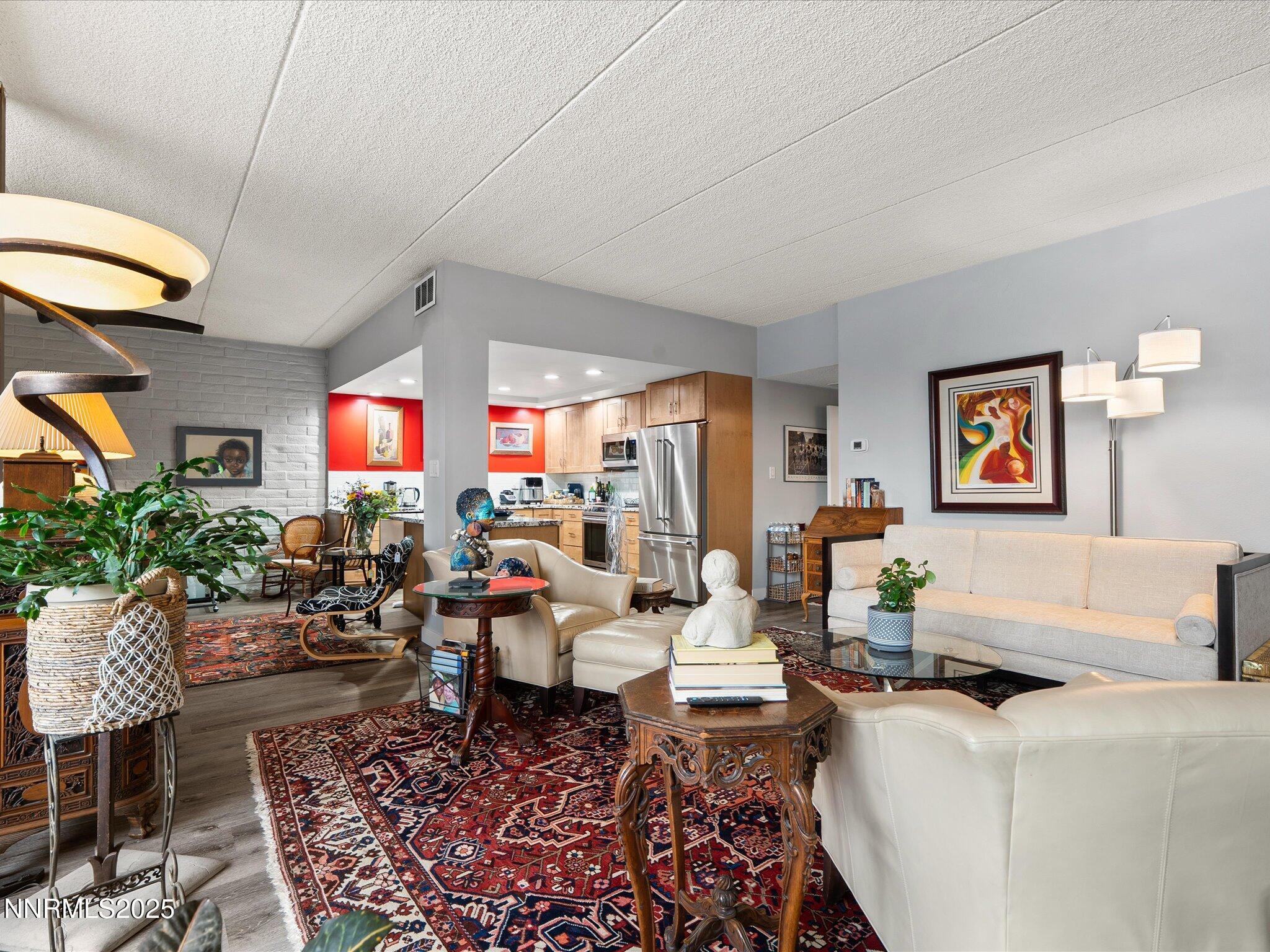 1200 Riverside Drive, Unit 1276 Reno, NV 89503 - Photo 12 of 47 a living room with fireplace furniture and a large window