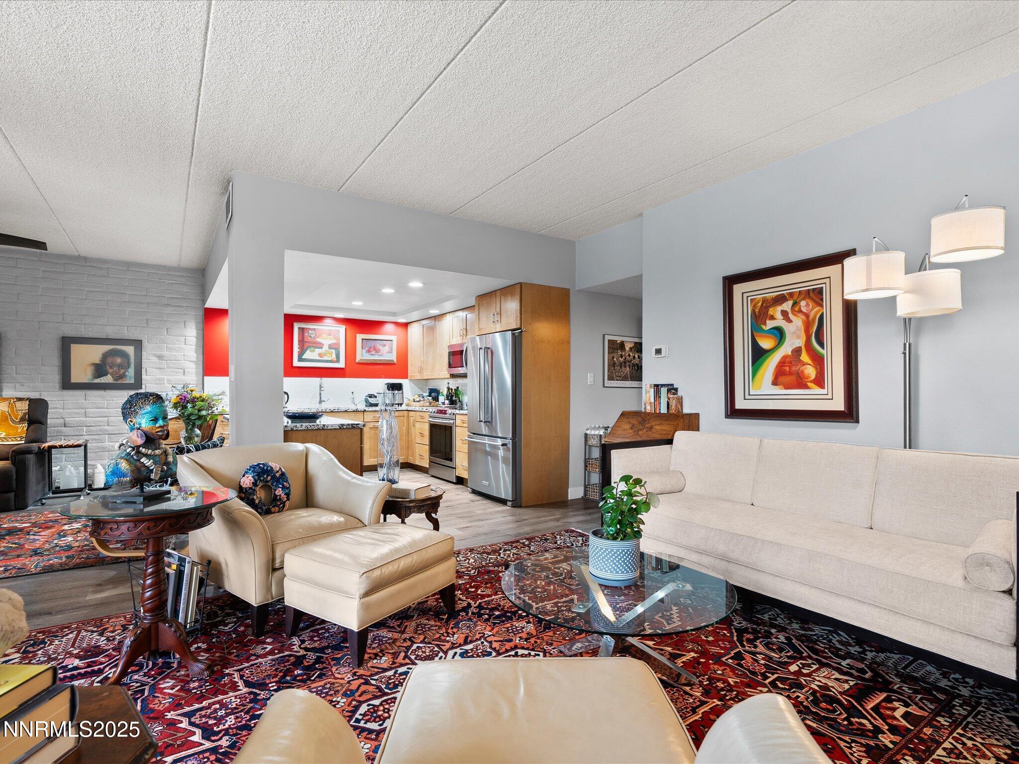 1200 Riverside Drive, Unit 1276 Reno, NV 89503 - Photo 13 of 47 a living room with furniture a rug and a painting on the wall