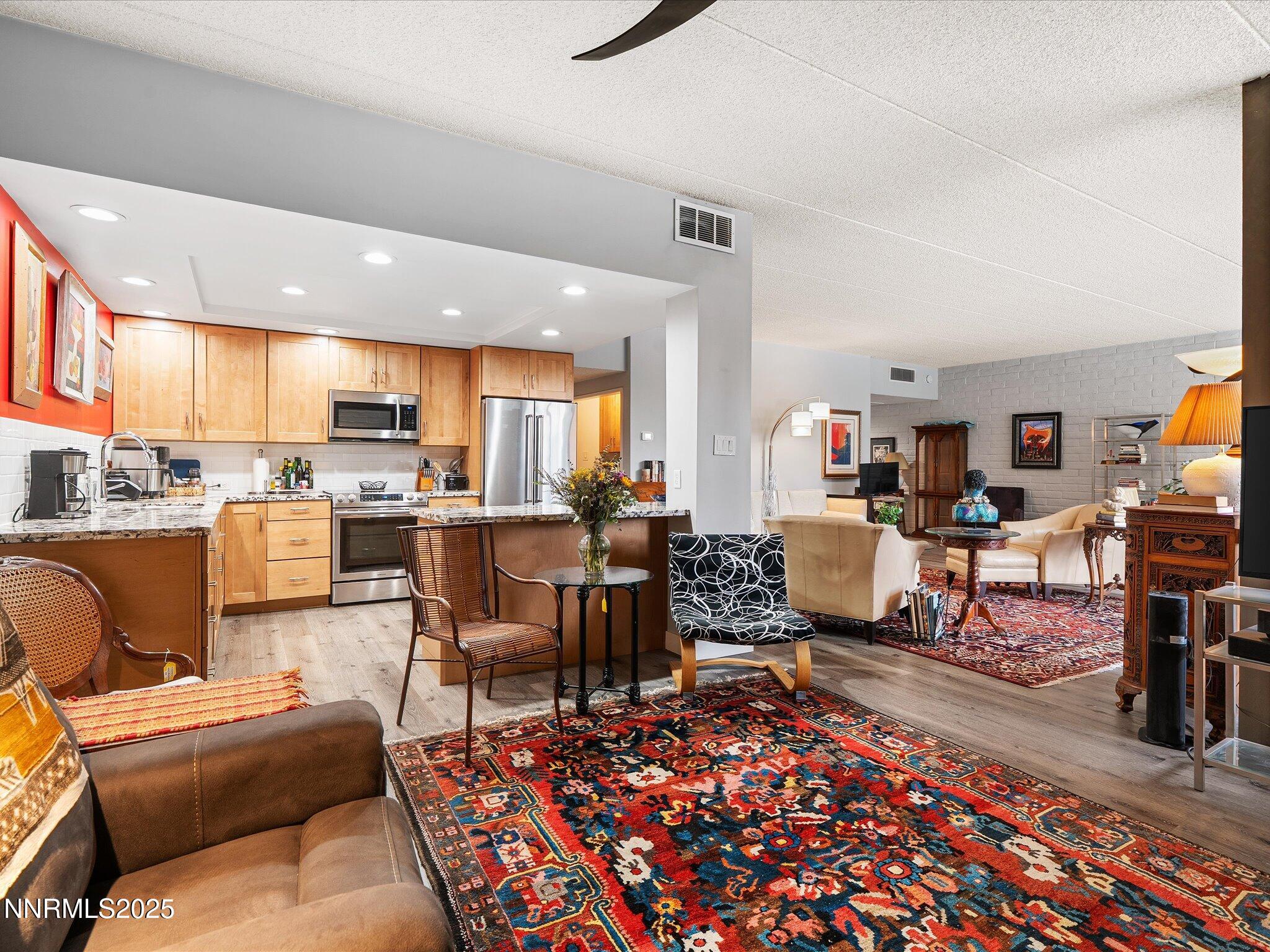 1200 Riverside Drive, Unit 1276 Reno, NV 89503 - Photo 19 of 47 a living room with furniture and a dining table with kitchen view