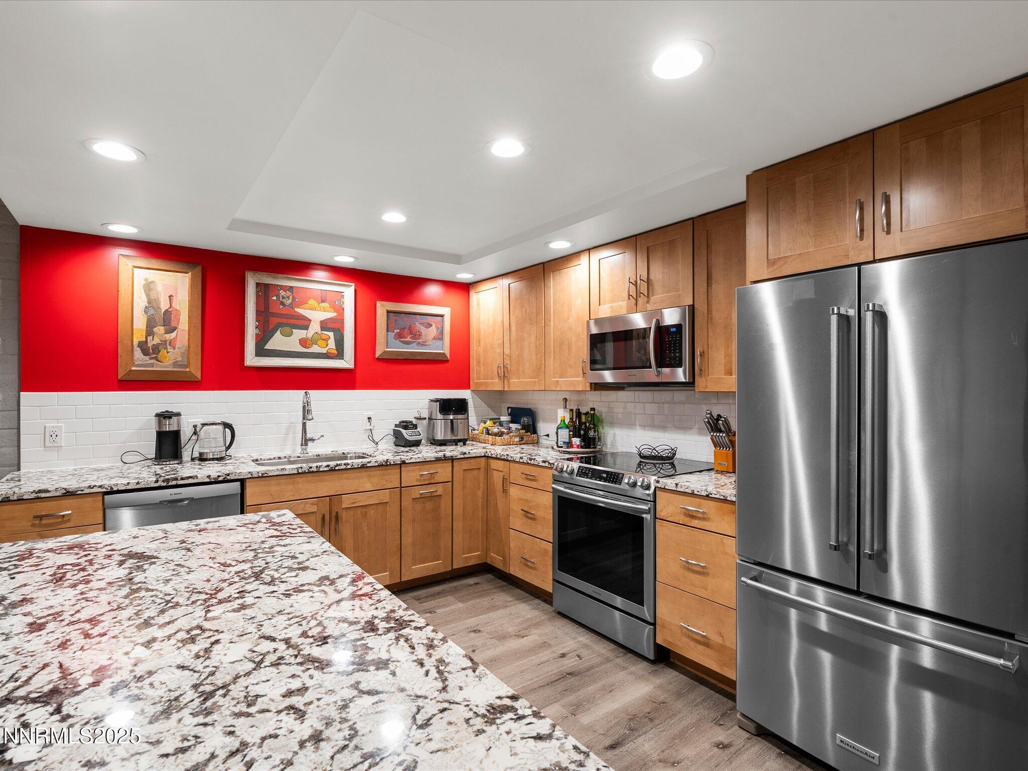 1200 Riverside Drive, Unit 1276 Reno, NV 89503 - Photo 21 of 47 a kitchen with stainless steel appliances granite countertop a refrigerator stove microwave and sink