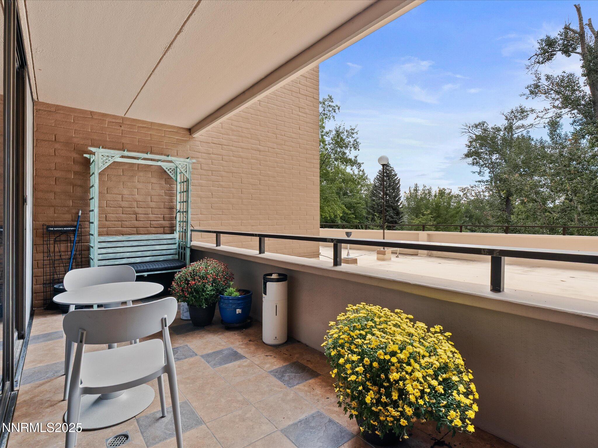 1200 Riverside Drive, Unit 1276 Reno, NV 89503 - Photo 24 of 47 a balcony with wooden floor and furniture