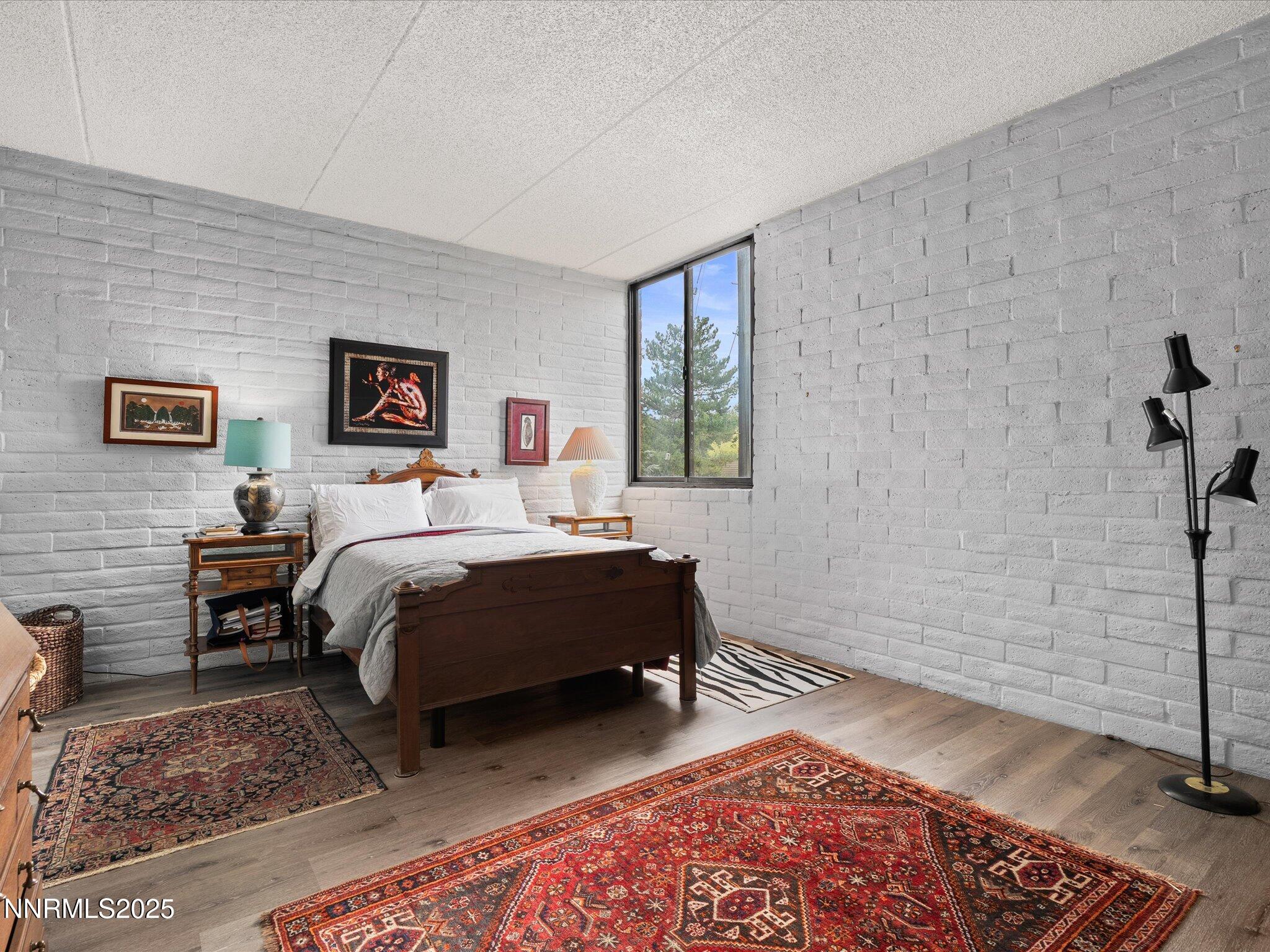 1200 Riverside Drive, Unit 1276 Reno, NV 89503 - Photo 25 of 47 a bedroom with a bed and wooden floor