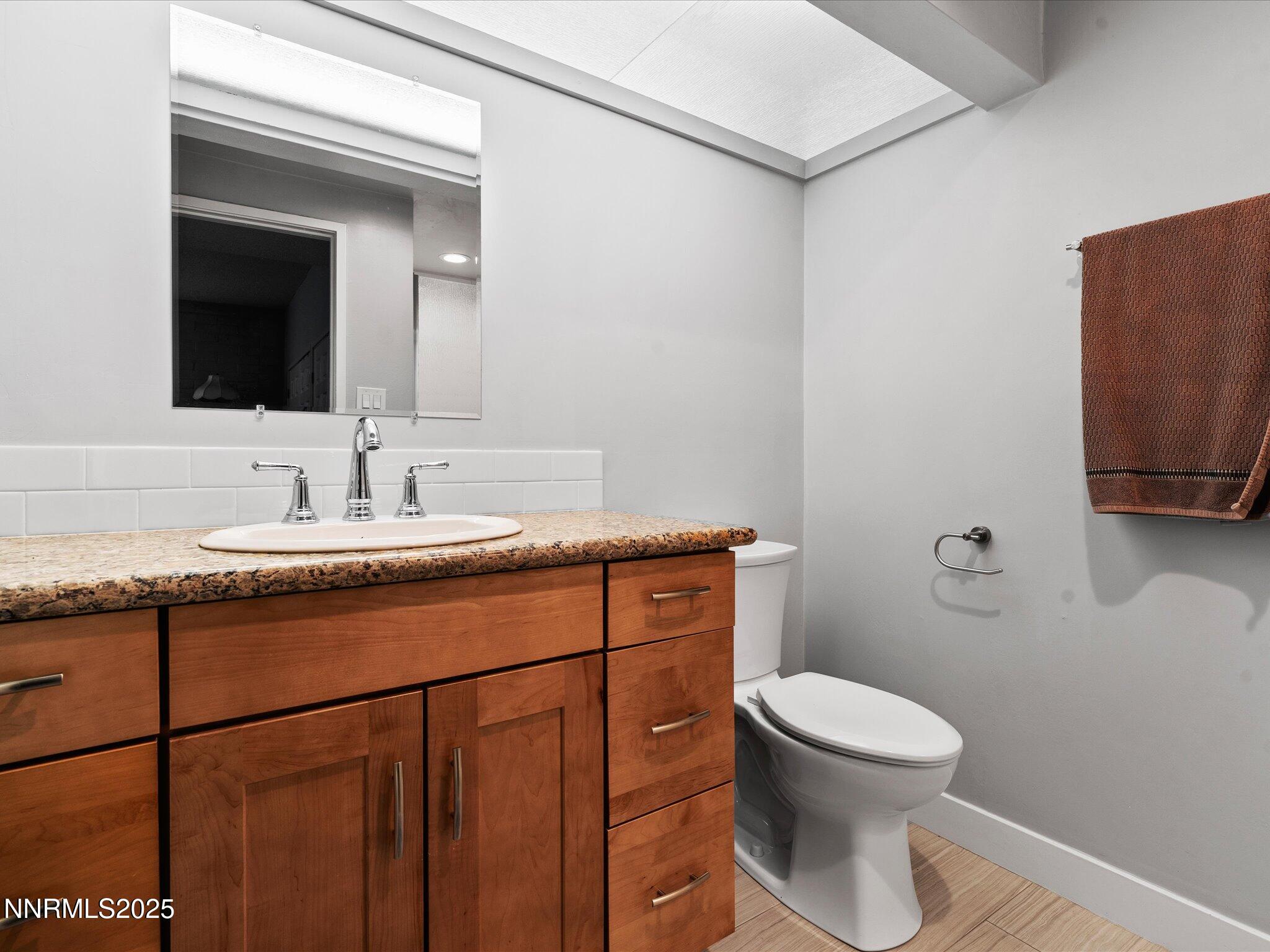 1200 Riverside Drive, Unit 1276 Reno, NV 89503 - Photo 32 of 47 a bathroom with a toilet a sink and mirror