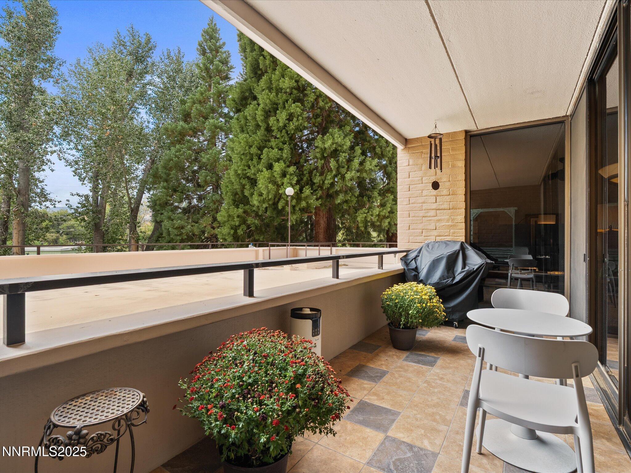 1200 Riverside Drive, Unit 1276 Reno, NV 89503 - Photo 4 of 47 a balcony with chairs and a potted plant