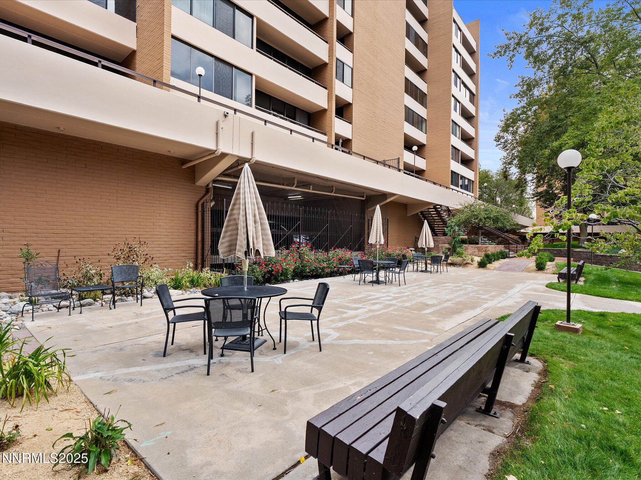 1200 Riverside Drive, Unit 1276 Reno, NV 89503 - Photo 41 of 47 a view of a patio with table and chairs potted plants and a large tree