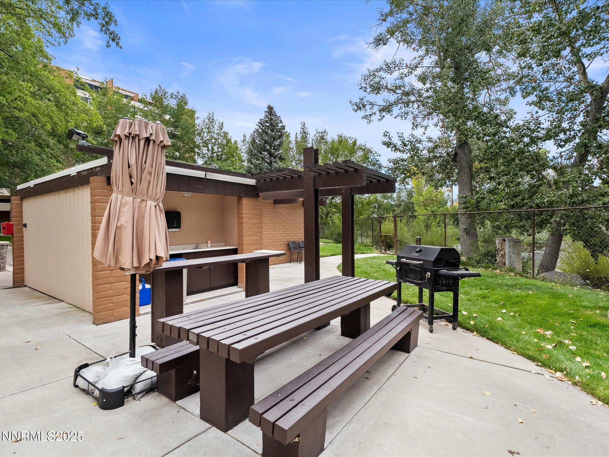 1200 Riverside Drive, Unit 1276 Reno, NV 89503 - Photo 42 of 47 a view of a patio with a table chairs and a barbeque