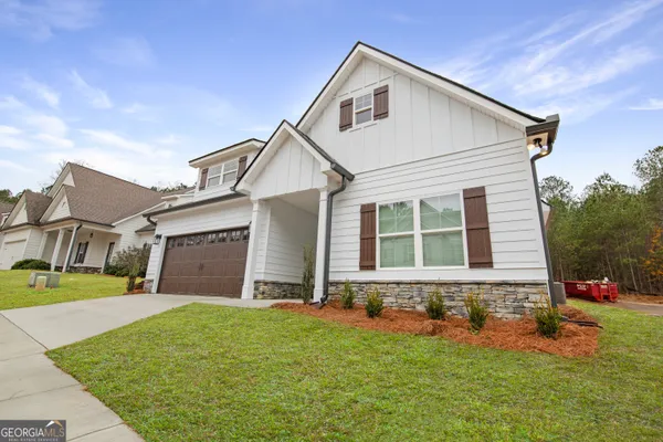 a front view of a house with a yard and garage