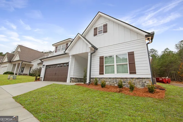 a front view of a house with a yard and garage