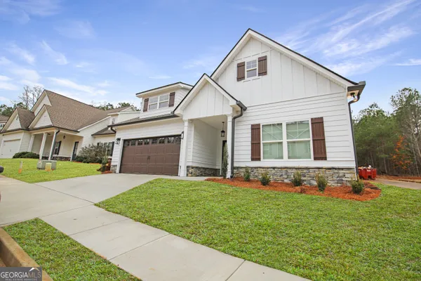 a front view of a house with a yard