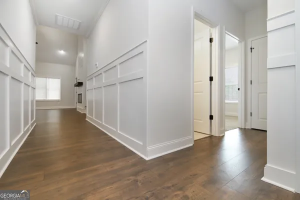 a view of a hallway with wooden floor