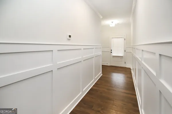 a view of a hallway with white walls