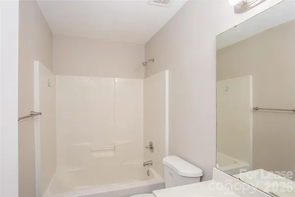 a bathroom with a toilet and shower
