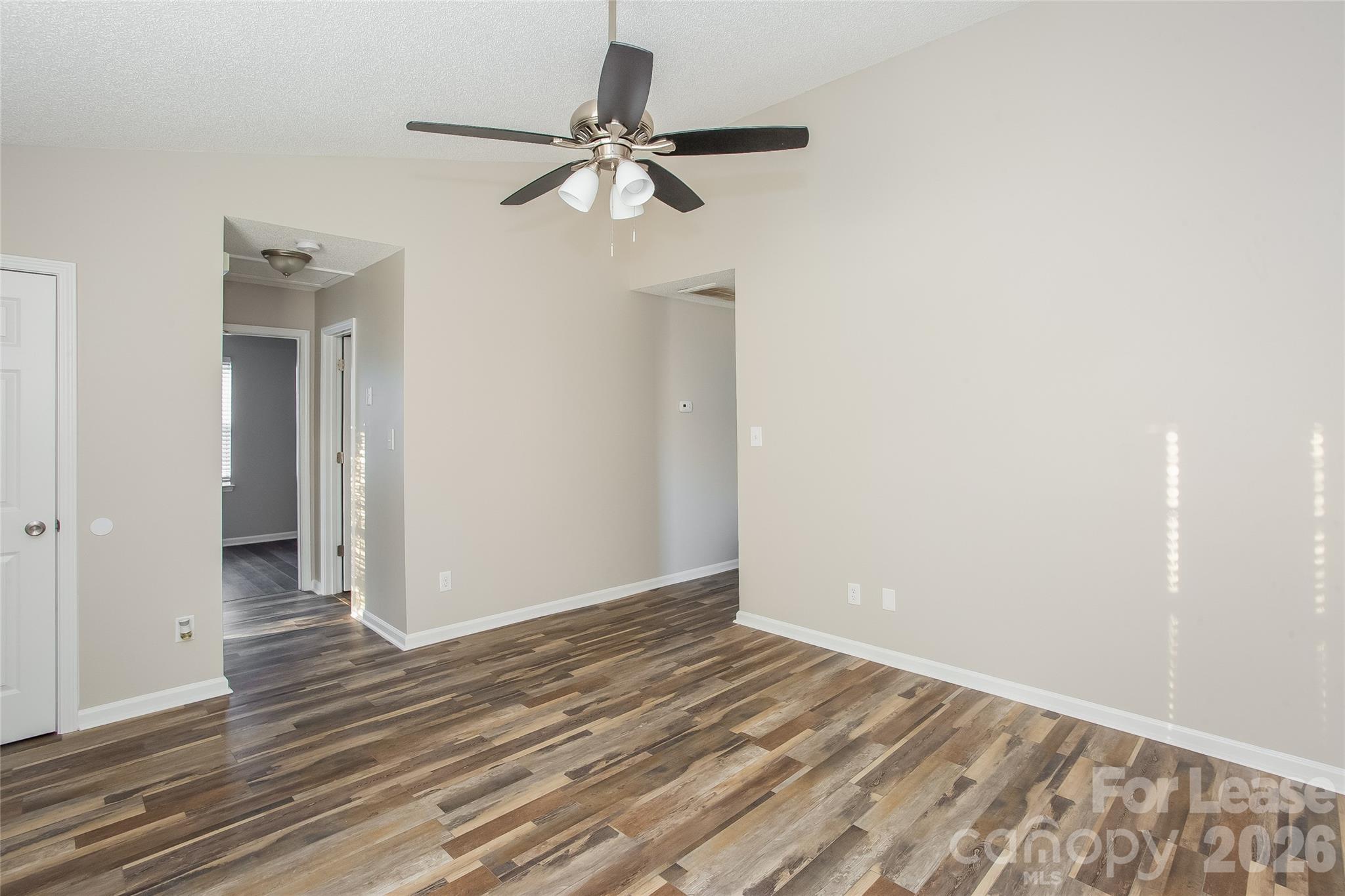 4262 Barley Street Southwest Concord, NC 28027 - Photo 6 of 15 a view of a room with wooden floor and a ceiling fan