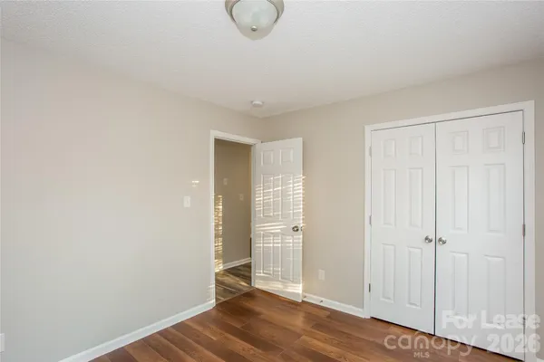a view of a room with wooden floor