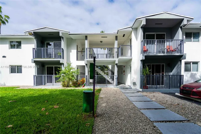 a view of a cafe with a table and chairs under an umbrella