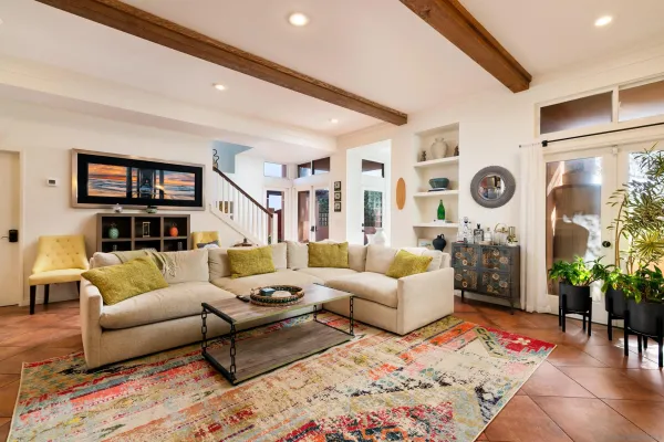a living room with furniture and a potted plant