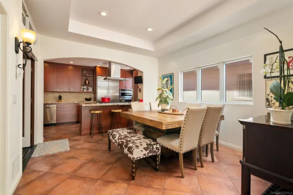 a kitchen with stainless steel appliances granite countertop a sink and a refrigerator