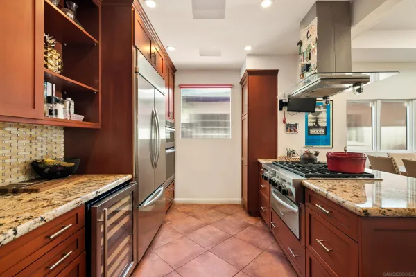 a view of a patio with a dining table and chairs with wooden floor and fence