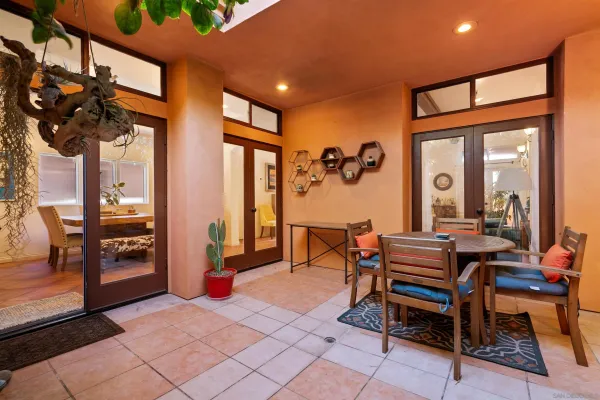 a view of a patio with couches and potted plants