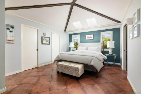 a bedroom with a bed and glass walk in closet