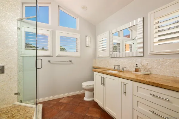 a living room with furniture a flat screen tv and a large window