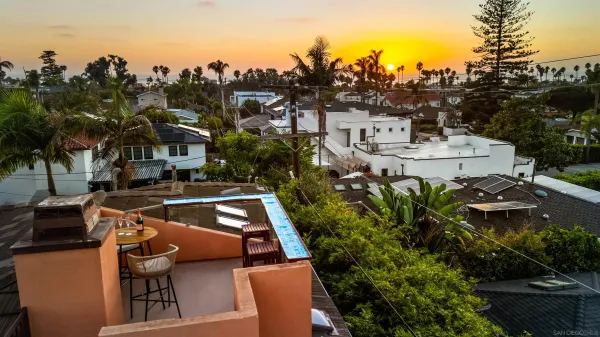 a front view of a house with outdoor seating
