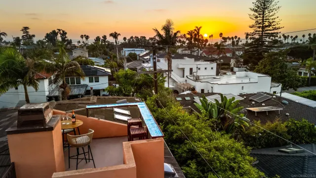 a front view of a house with outdoor seating
