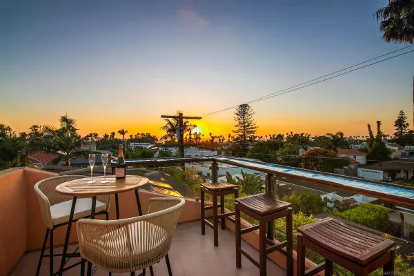 a backyard of a house with table and chairs