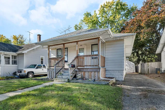 a front view of house with yard and trees around