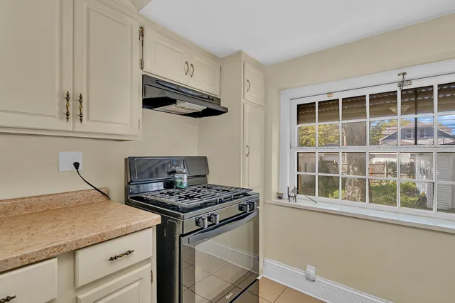 a kitchen with stainless steel appliances a stove a sink and a microwave