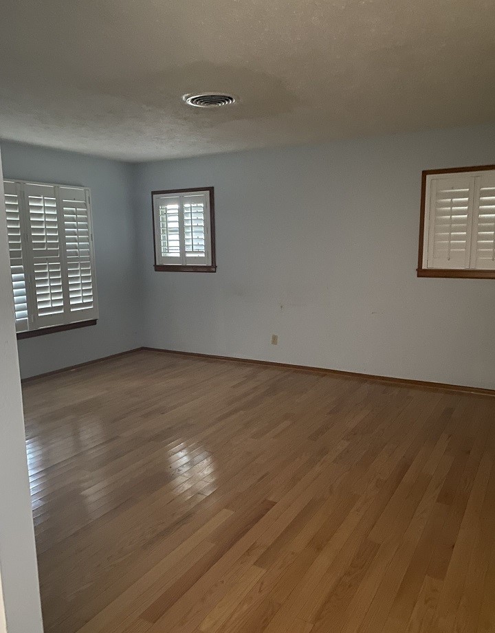 1119 Jefferson Street Alice, TX 78332 - Photo 15 of 23 an empty room with wooden floor and windows