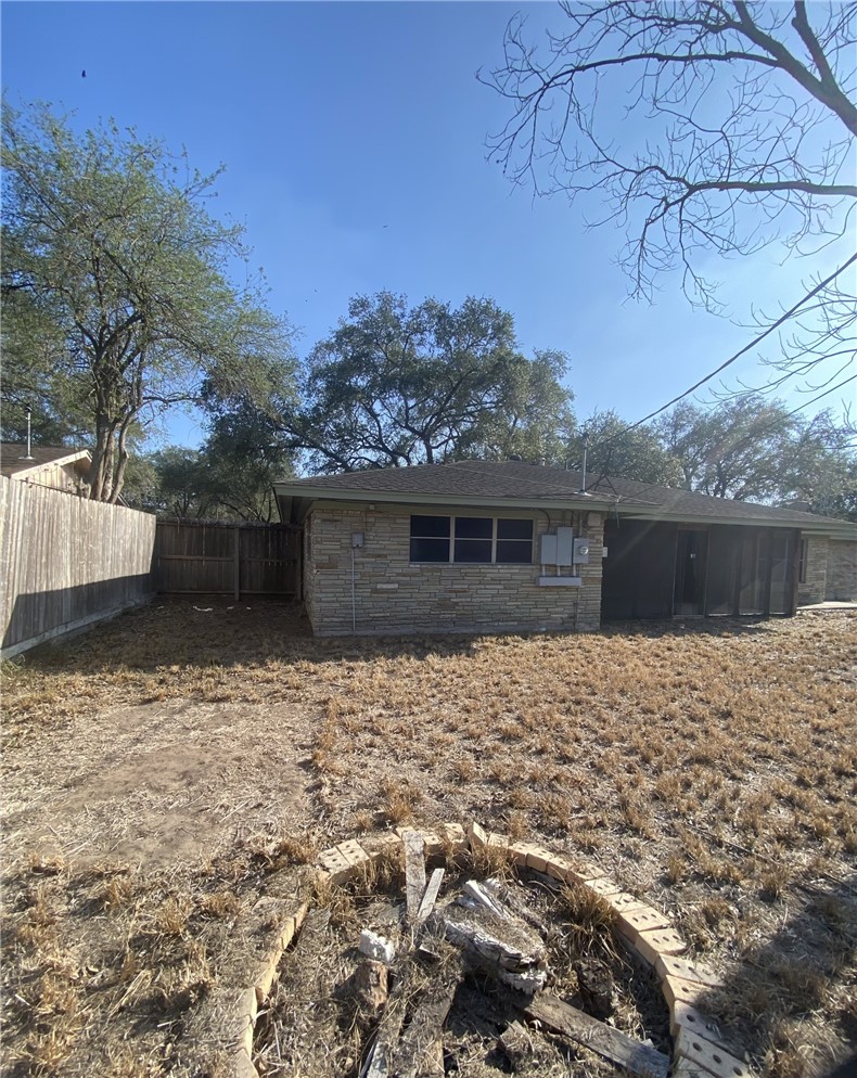 1119 Jefferson Street Alice, TX 78332 - Photo 20 of 23 a backyard of a house with large trees and wooden fence