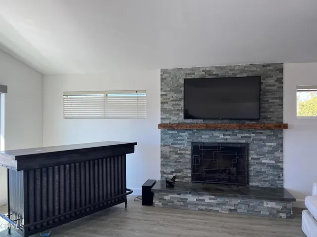a living room with a fireplace and a flat screen tv