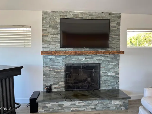a living room with fireplace furniture and a flat screen tv