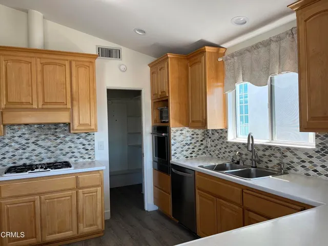 a kitchen with a large window and a sink