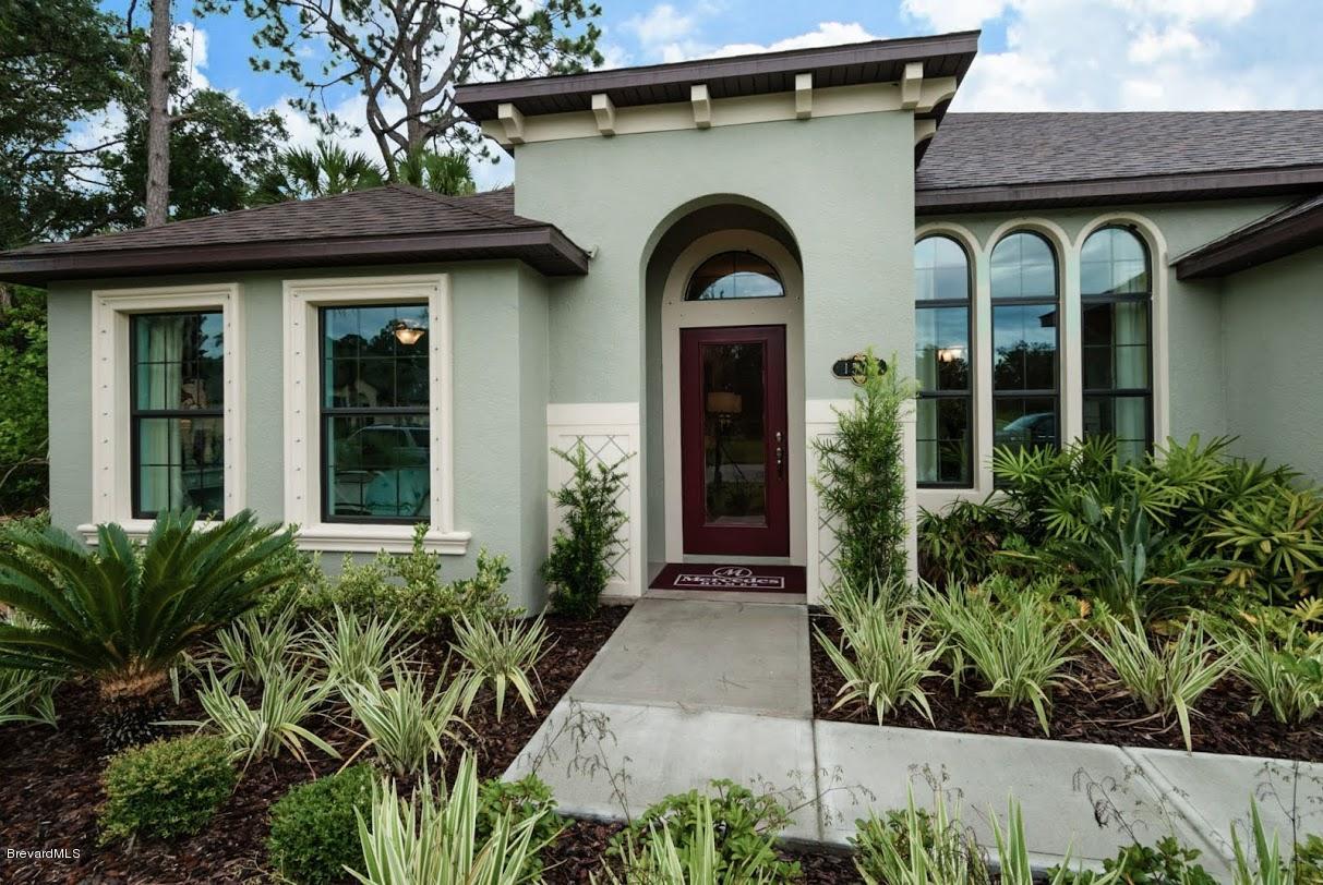 a front view of a house with garden