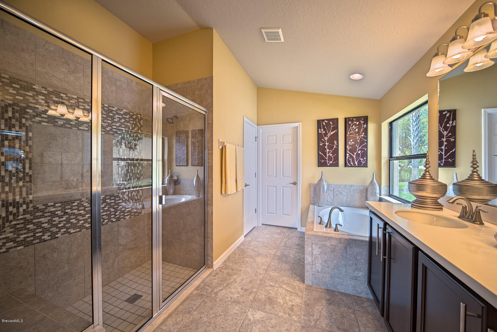 4082 Ruthann Circle Melbourne, FL 32934 - Photo 11 of 13 a view of a large kitchen with kitchen island granite countertop a refrigerator and a sink