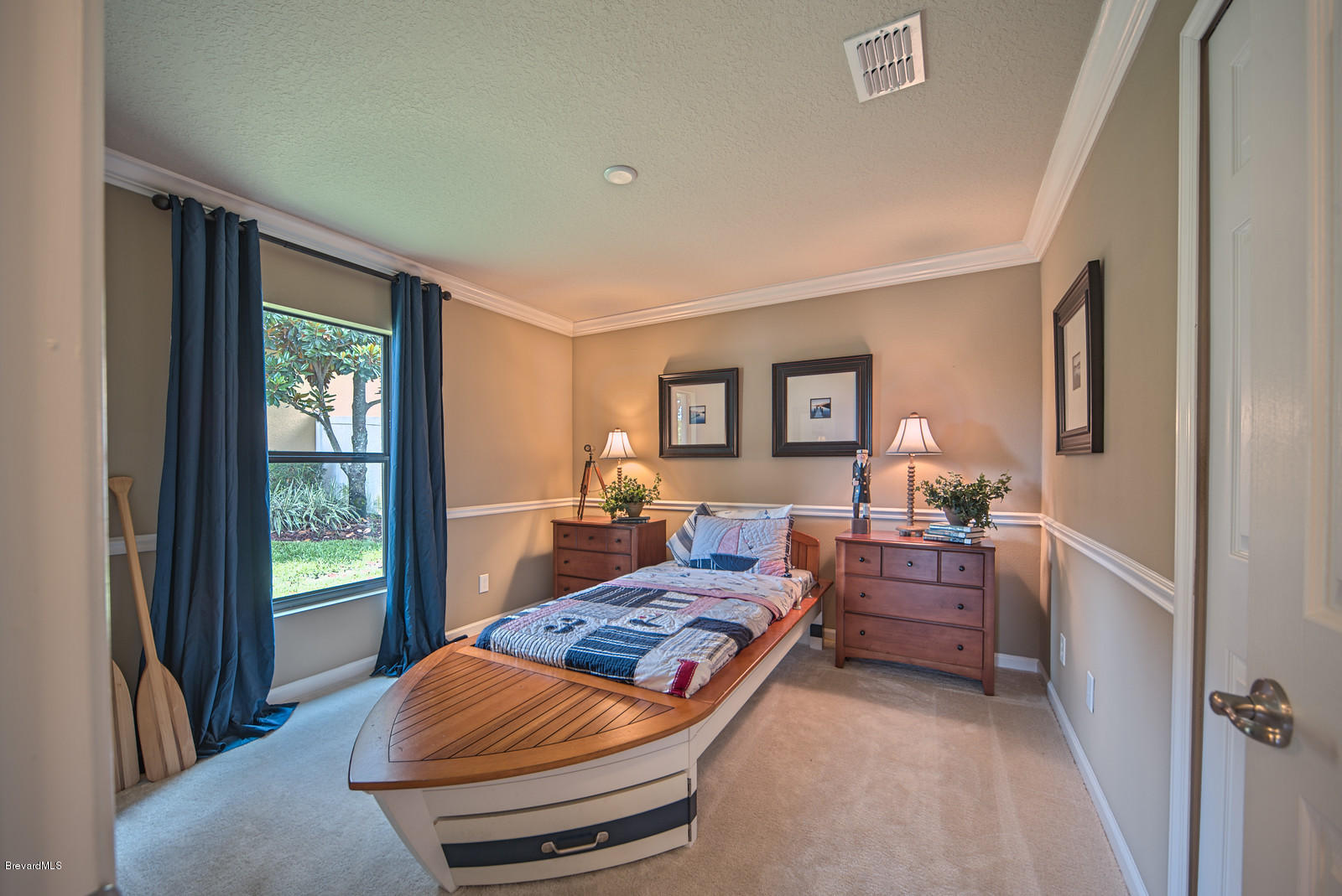 4082 Ruthann Circle Melbourne, FL 32934 - Photo 12 of 13 a bedroom with furniture and a window