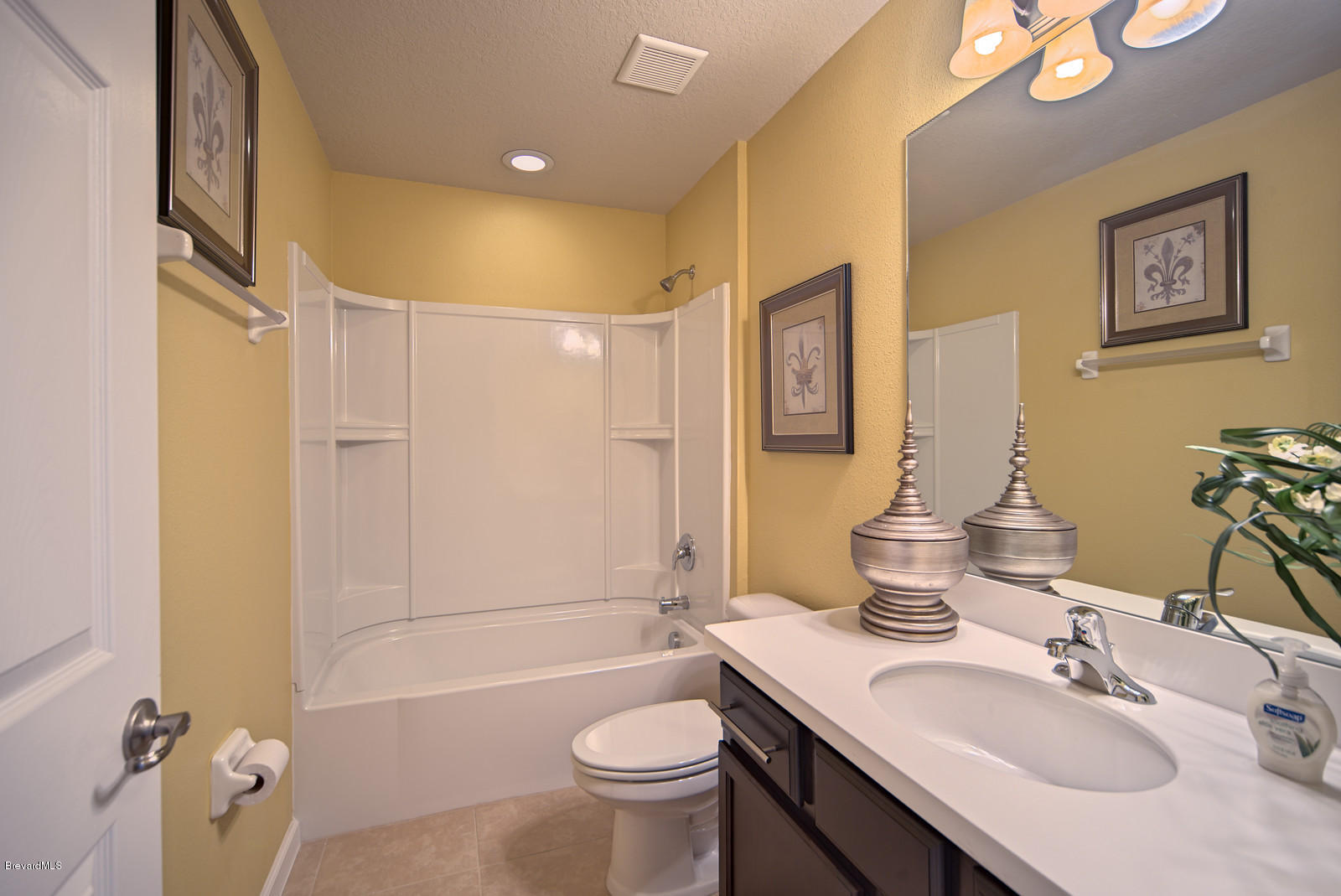 4082 Ruthann Circle Melbourne, FL 32934 - Photo 13 of 13 a bathroom with a sink toilet tub and shower