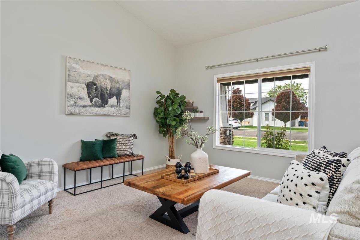 80 Cobblestone Court Middleton, ID 83644 - Photo 6 of 48 Living room featuring a vaulted ceiling and light gray wall paint