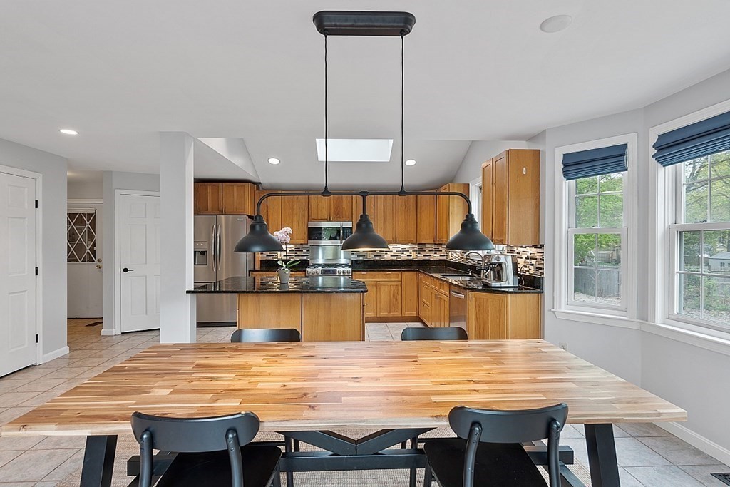 176 Southville Road Southborough, MA 01772 - Photo 12 of 39 a dining table with kitchen island and stainless steel appliances