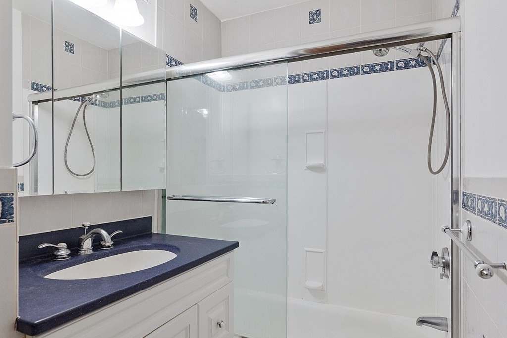 176 Southville Road Southborough, MA 01772 - Photo 15 of 39 a bathroom with a sink vanity mirror and shower