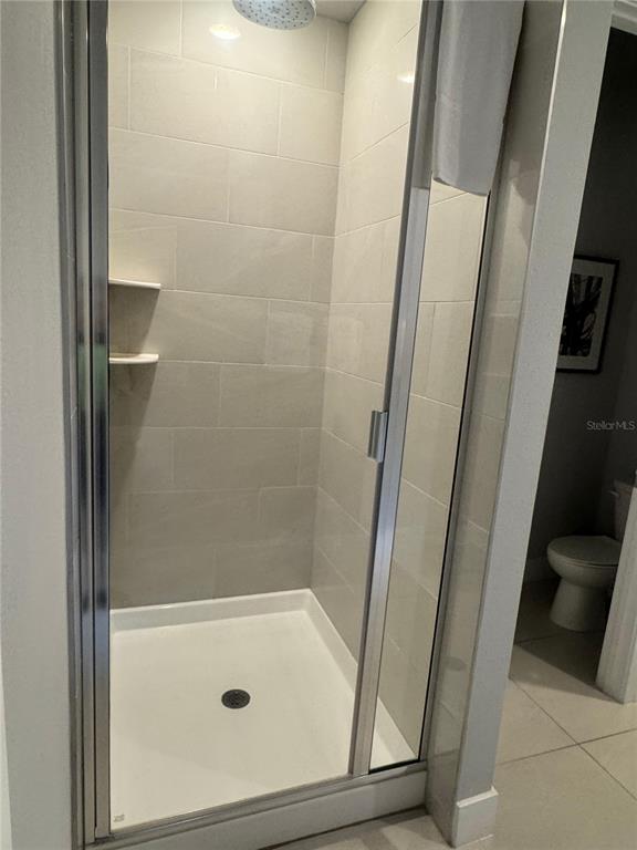 7770 Sandy Ridge Drive, Unit 210 Reunion, FL 34747 - Photo 9 of 42 a bathroom with a glass door shower and vanity